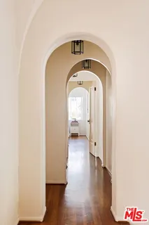 a front view of a house with a yard and mountain view