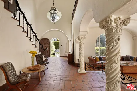 a living room with furniture a fireplace and flat screen tv