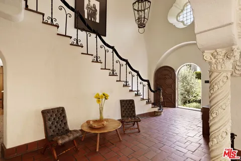 a living room with furniture a fireplace and a table