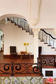 a living room with furniture a fireplace and a floor to ceiling window