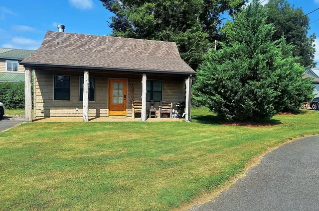 a front view of a house with a garden