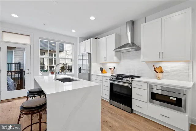 a kitchen with cabinets and stainless steel appliances