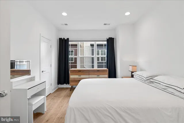 a bedroom with a large bed and a large window