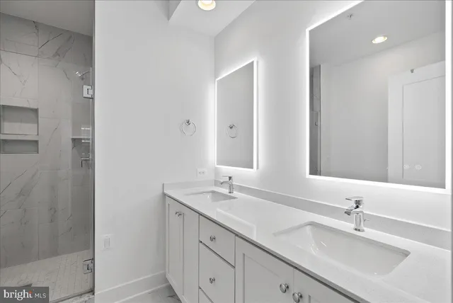 a bathroom with double sink and a mirror