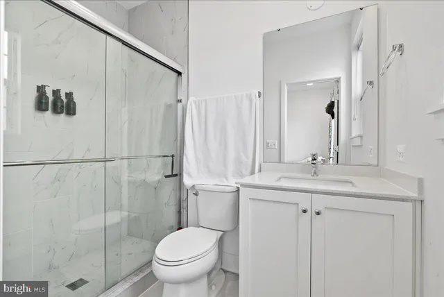 a bathroom with a toilet sink and shower