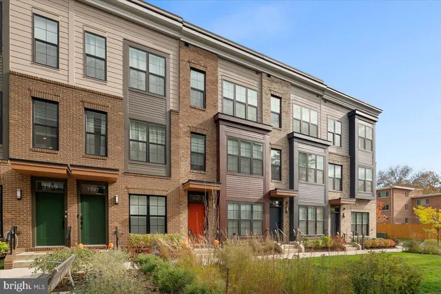 a front view of a building with a yard