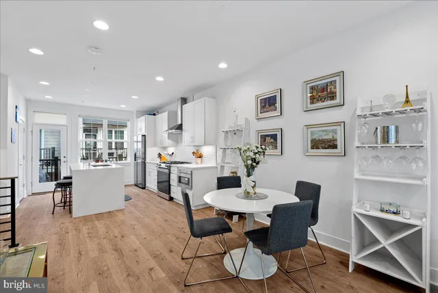 a living room with furniture a dining table and kitchen view