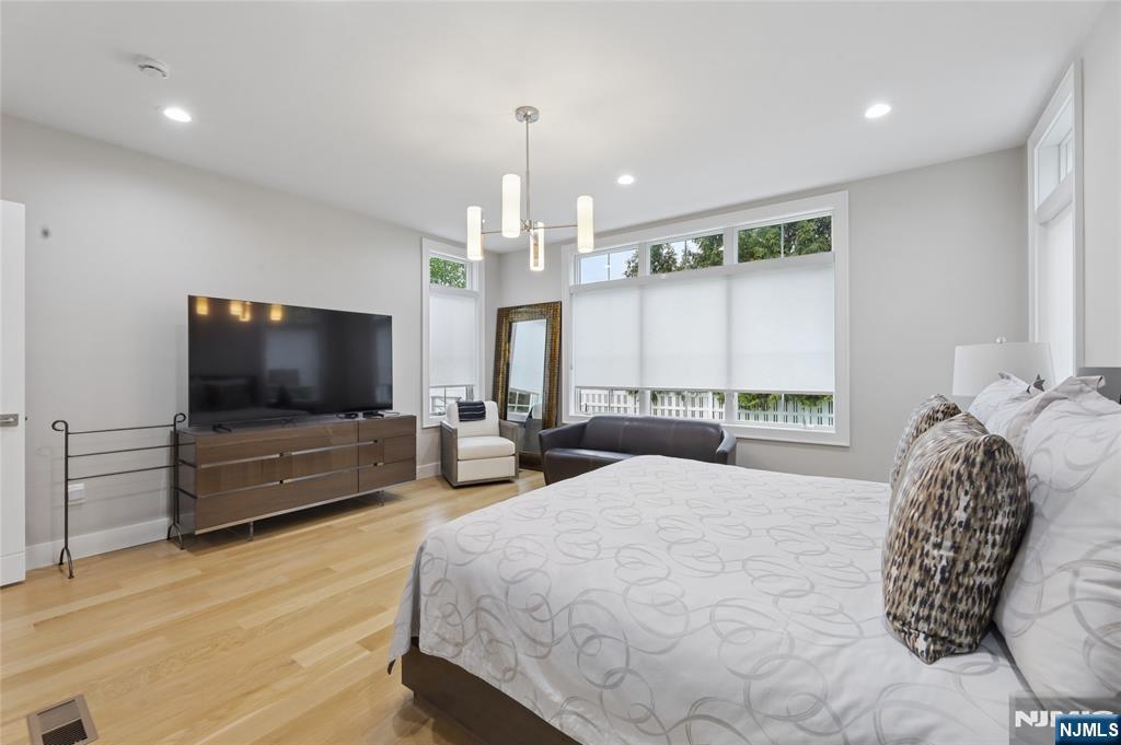 31 Engleside Street Cresskill, NJ 07626 - Photo 19 of 49 a spacious bedroom with a large bed and a flat screen tv