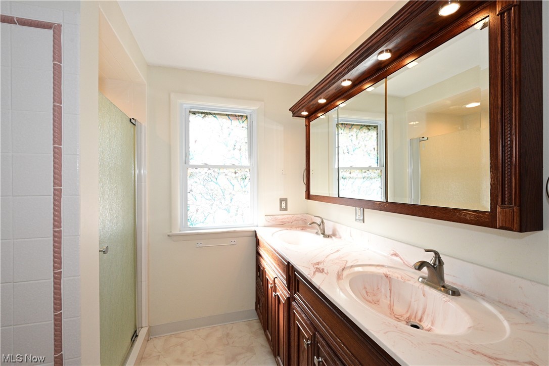 3798 Hillbrook Road Cleveland, OH 44118 - Photo 29 of 34 Bathroom with walk in shower, a wealth of natural light, dual vanity, and tile flooring