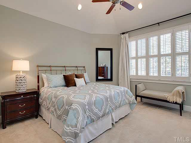 2017 Ridge Road Raleigh, NC 27607 - Photo 11 of 25 a bedroom with a bed and a chandelier