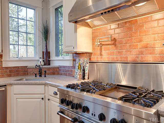 2017 Ridge Road Raleigh, NC 27607 - Photo 8 of 25 a kitchen with a stove a sink and a window