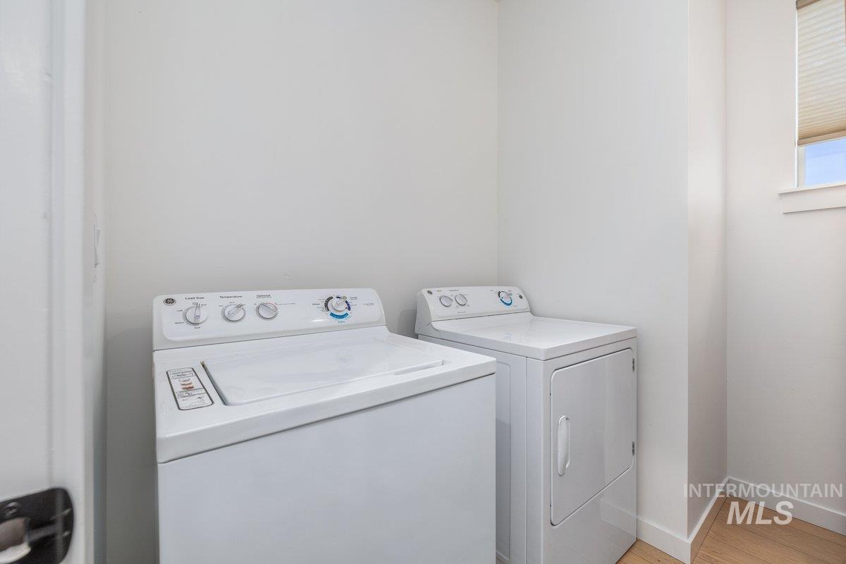 1380 West Chilitna Street Meridian, ID 83642 - Photo 41 of 50 Dedicated laundry area featuring a white top-load washing machine and a white front-load dryer