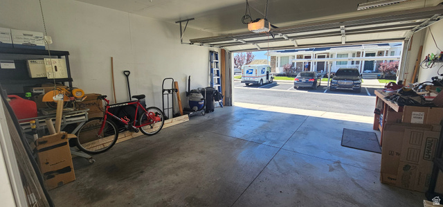 1674 Eastridge Road Price, UT 84501 - Photo 34 of 34 Spacious garage featuring a concrete floor, painted walls, and an automatic overhead door