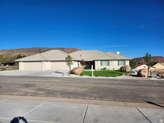 230 Boulder Way Leeds, UT 84746 - Photo 3 of 72 Single story home with a front yard, a mountain view, driveway, a garage, and a chimney
