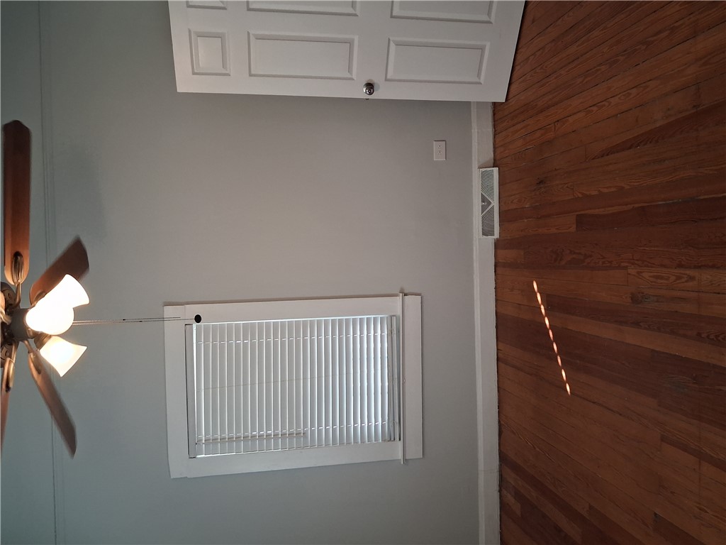 6 Allen Street Pelzer, SC 29669 - Photo 13 of 13 Warm hardwood floors and a ceiling fan create a comfortable atmosphere.