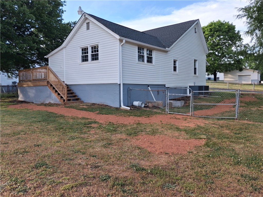 6 Allen Street Pelzer, SC 29669 - Photo 5 of 13 This charming home offers a spacious deck and ample outdoor area.