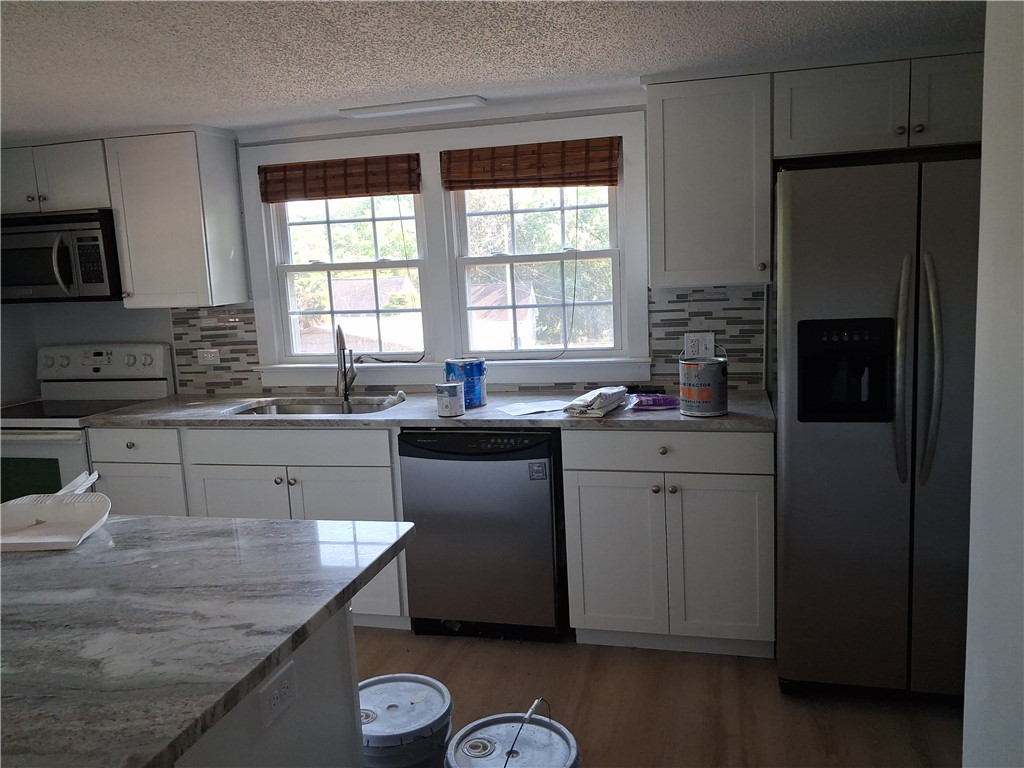 6 Allen Street Pelzer, SC 29669 - Photo 6 of 13 This newly updated kitchen offers ample counter space, modern appliances, and abundant natural light.