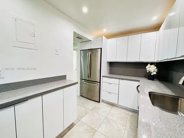 a kitchen with stainless steel appliances a refrigerator sink and cabinets