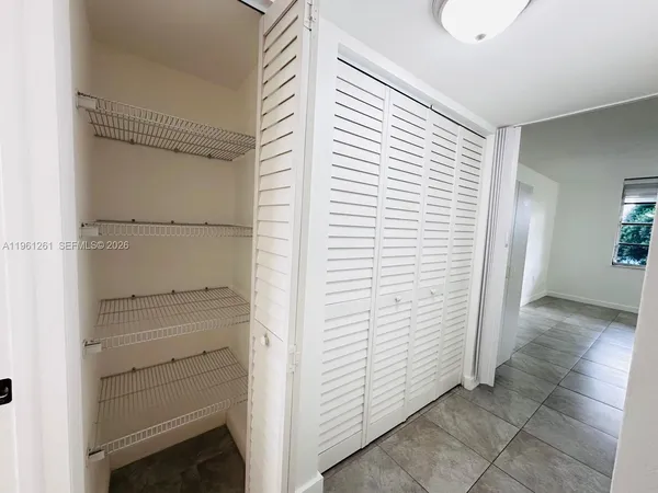 a view of walk in closet with empty racks