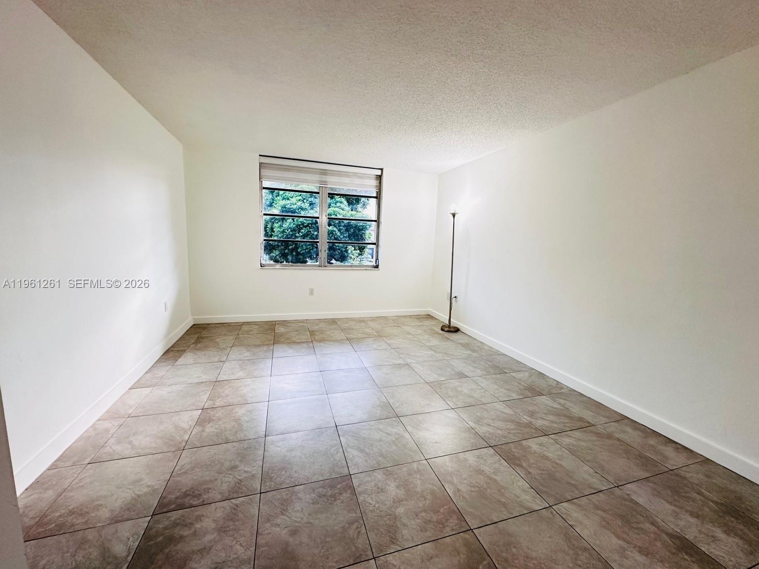 3490 Foxcroft Road, Unit B208 Miramar, FL 33025 - Photo 17 of 32 a view of an empty room with a window