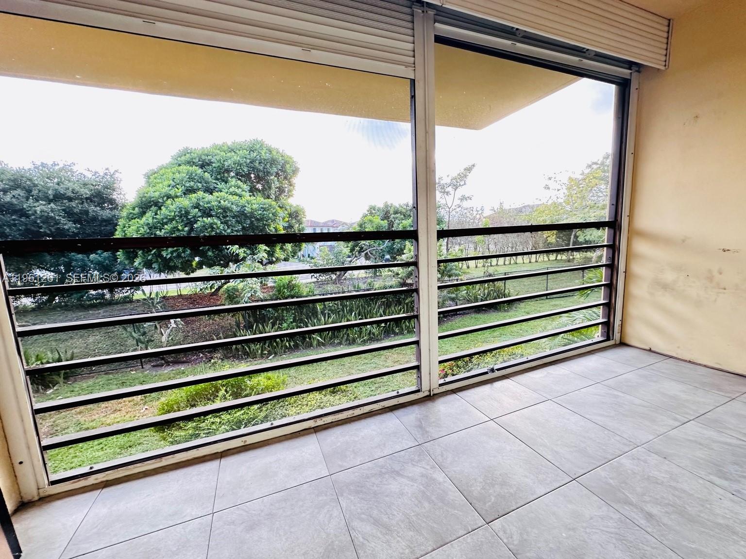 3490 Foxcroft Road, Unit B208 Miramar, FL 33025 - Photo 19 of 32 a view of a couple of benches sitting in front of a window