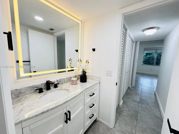 a bathroom with a double vanity sink and mirror