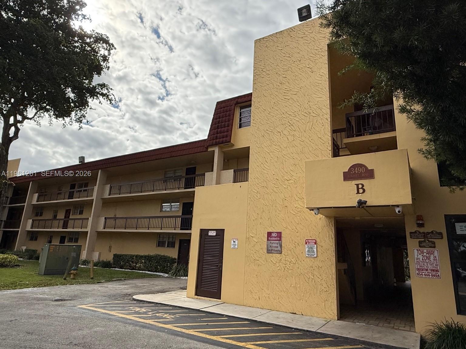 3490 Foxcroft Road, Unit B208 Miramar, FL 33025 - Photo 2 of 32 a front view of a house with a yard