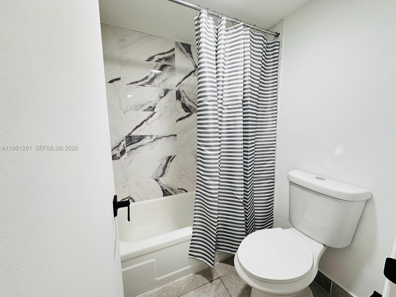 3490 Foxcroft Road, Unit B208 Miramar, FL 33025 - Photo 23 of 32 a white toilet sitting next to a bathroom sink
