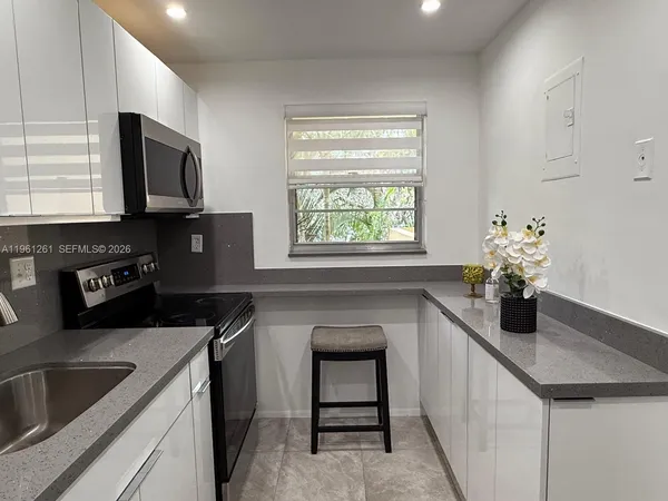 a kitchen with a sink stove and microwave