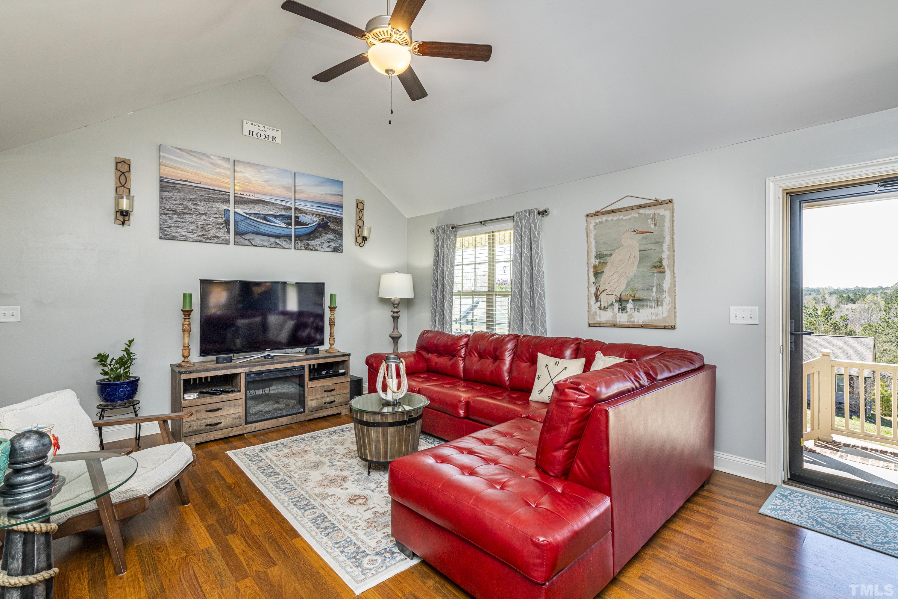 312 Wick Road Stem, NC 27581 - Photo 11 of 34 a living room with furniture and a flat screen tv