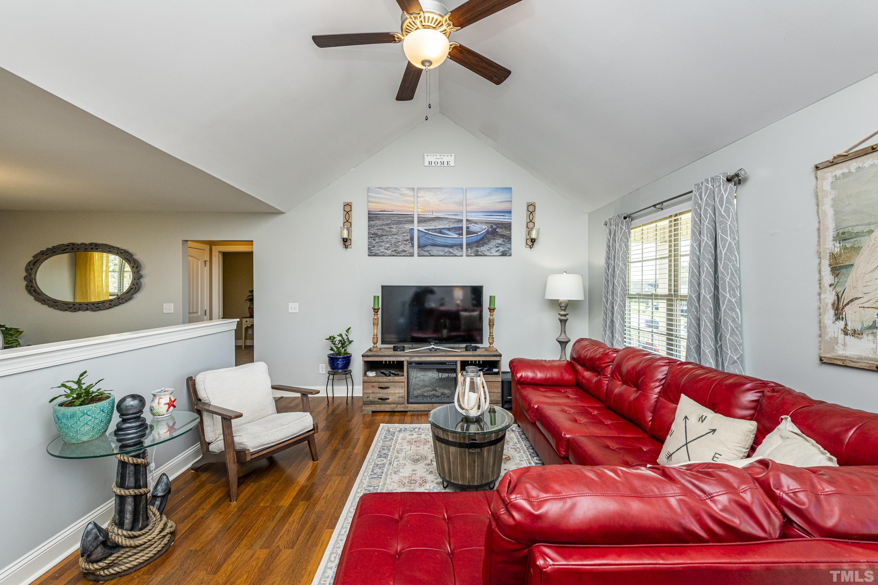 312 Wick Road Stem, NC 27581 - Photo 13 of 34 a living room with furniture a flat screen tv and a fireplace