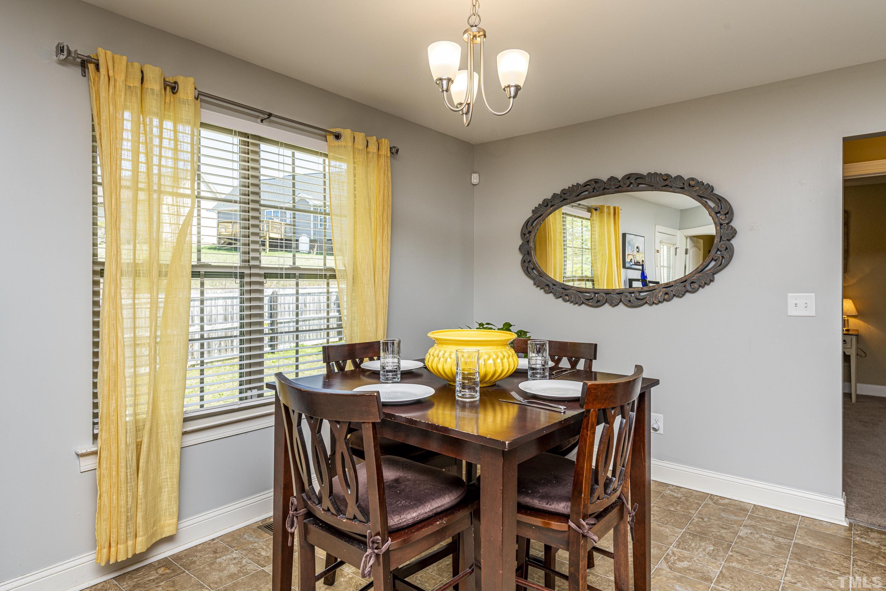 312 Wick Road Stem, NC 27581 - Photo 16 of 34 a dining room with furniture and a window