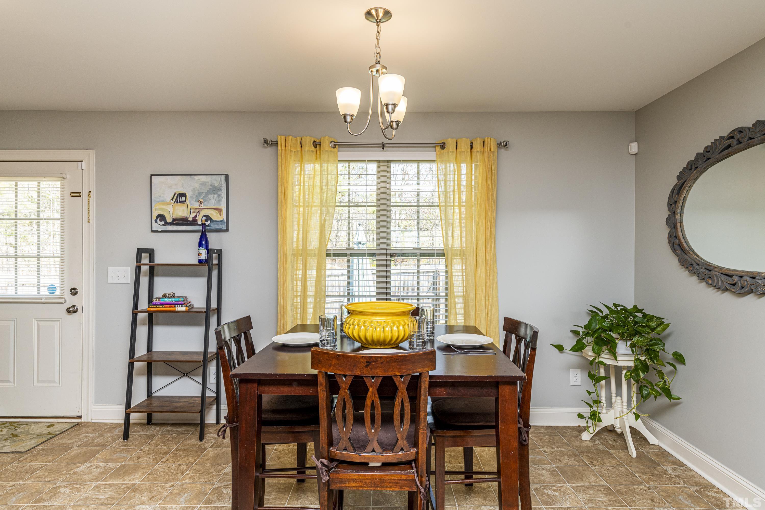 312 Wick Road Stem, NC 27581 - Photo 17 of 34 a dining room with furniture and window