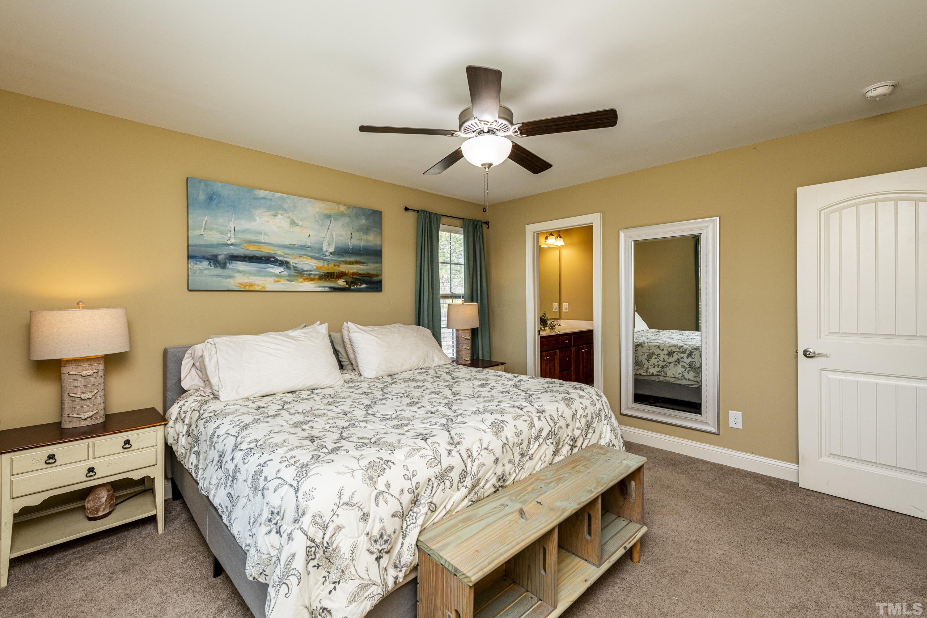 312 Wick Road Stem, NC 27581 - Photo 19 of 34 a bedroom with a bed and ceiling fan
