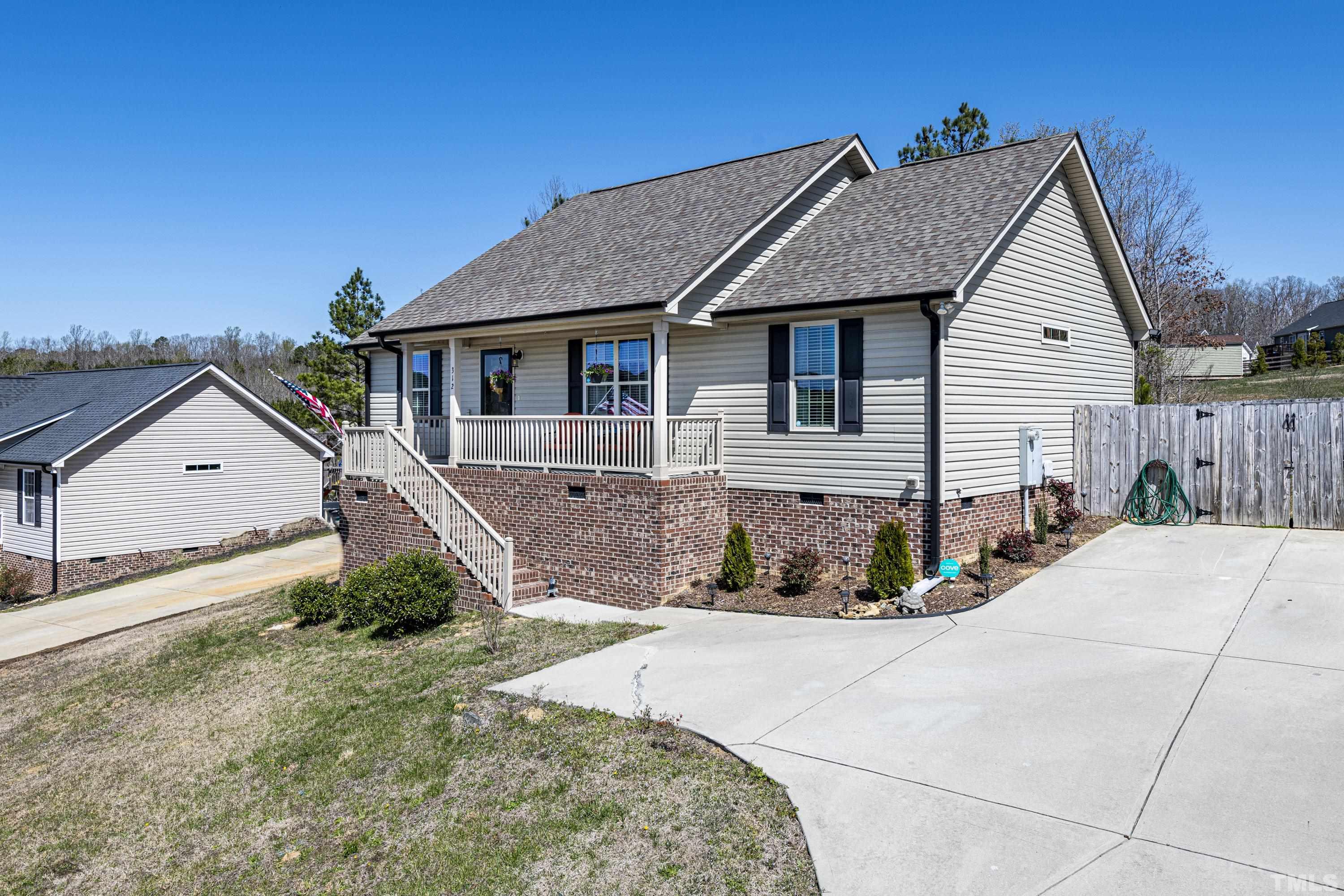 312 Wick Road Stem, NC 27581 - Photo 2 of 34 a front view of a house with a yard