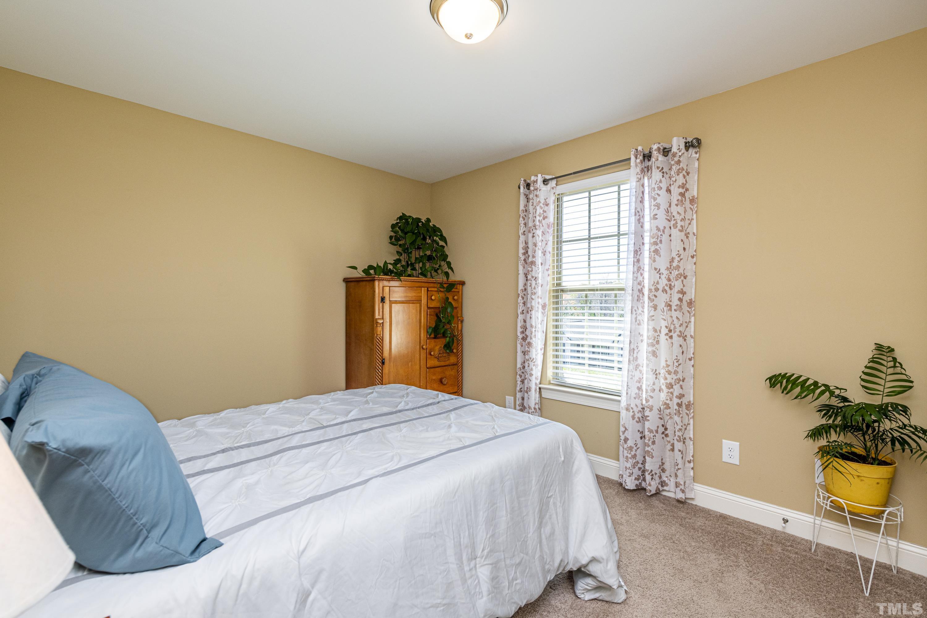 312 Wick Road Stem, NC 27581 - Photo 22 of 34 a bedroom with a bed and a window