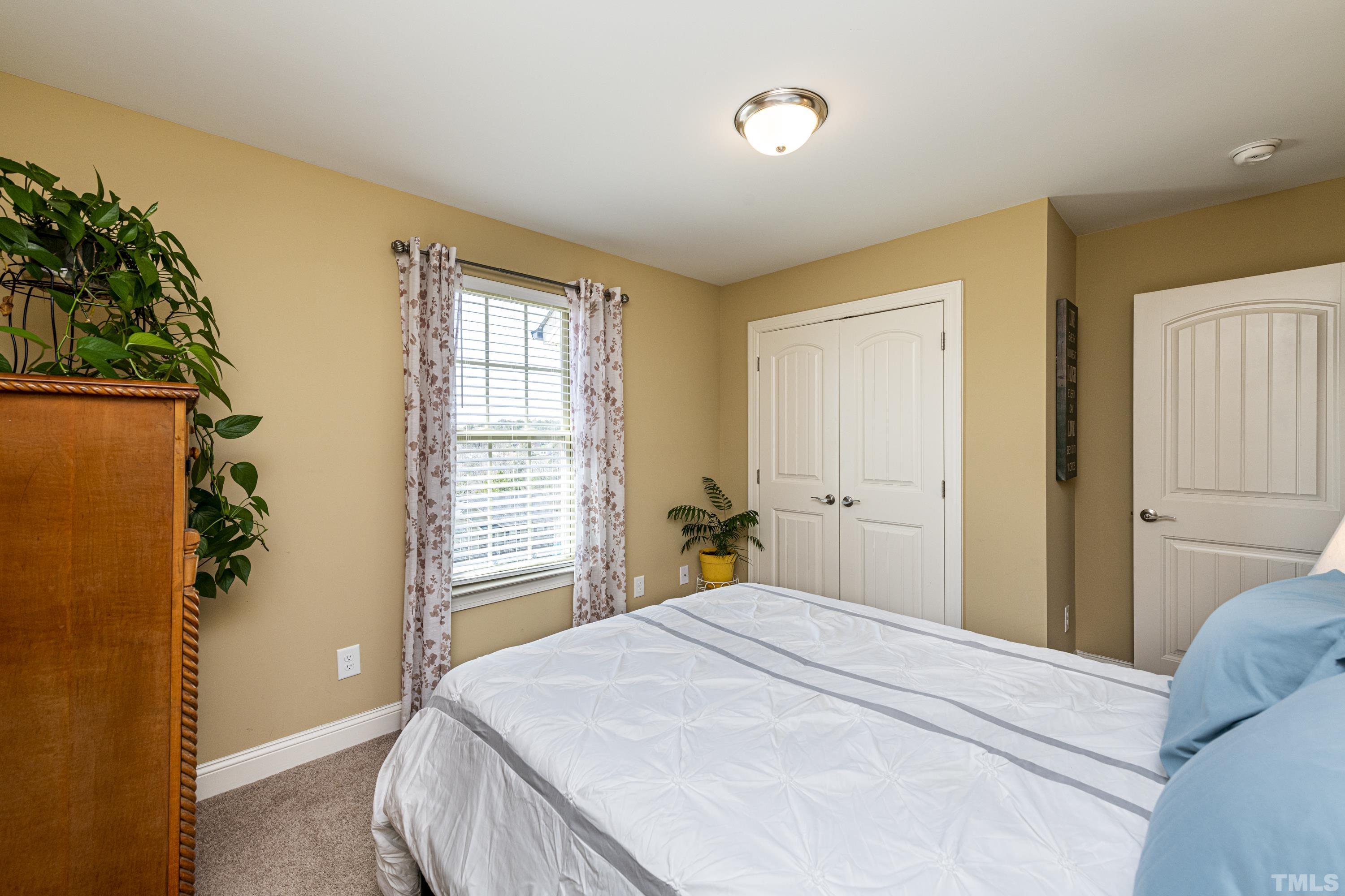 312 Wick Road Stem, NC 27581 - Photo 23 of 34 a bedroom with a bed and a window