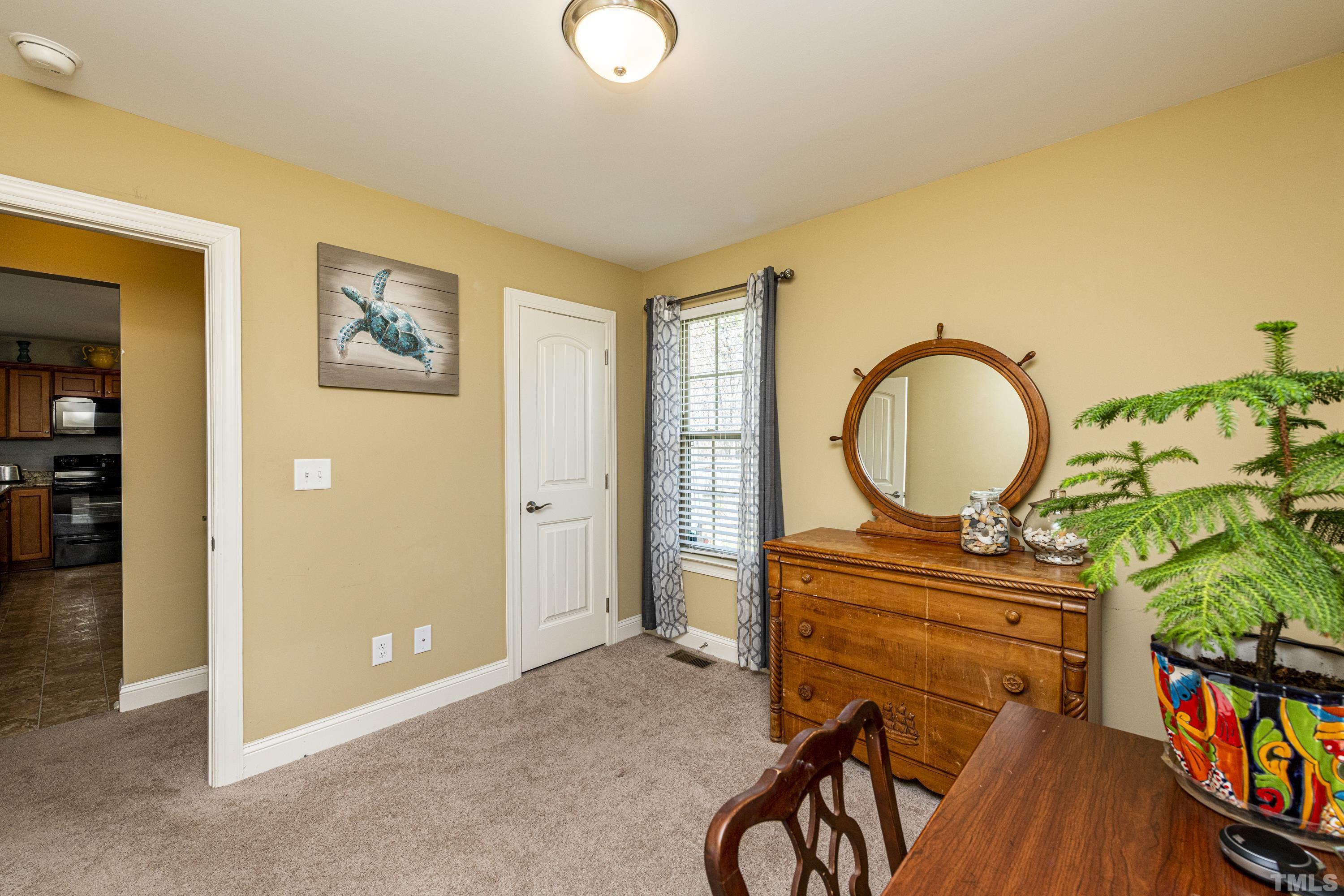 312 Wick Road Stem, NC 27581 - Photo 26 of 34 a living room with furniture and a flat screen tv