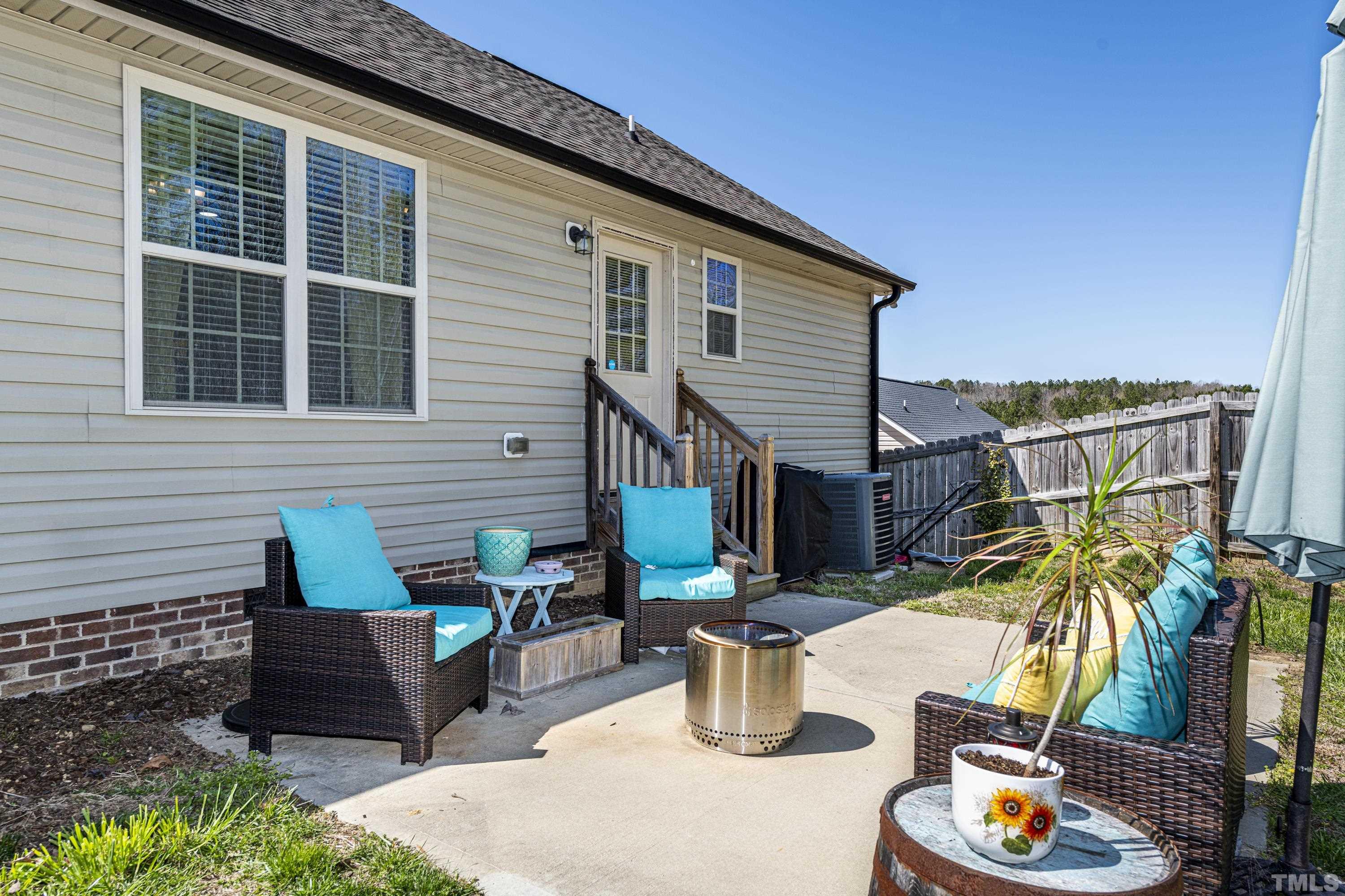 312 Wick Road Stem, NC 27581 - Photo 28 of 34 a view of a patio with table and chairs and potted plants