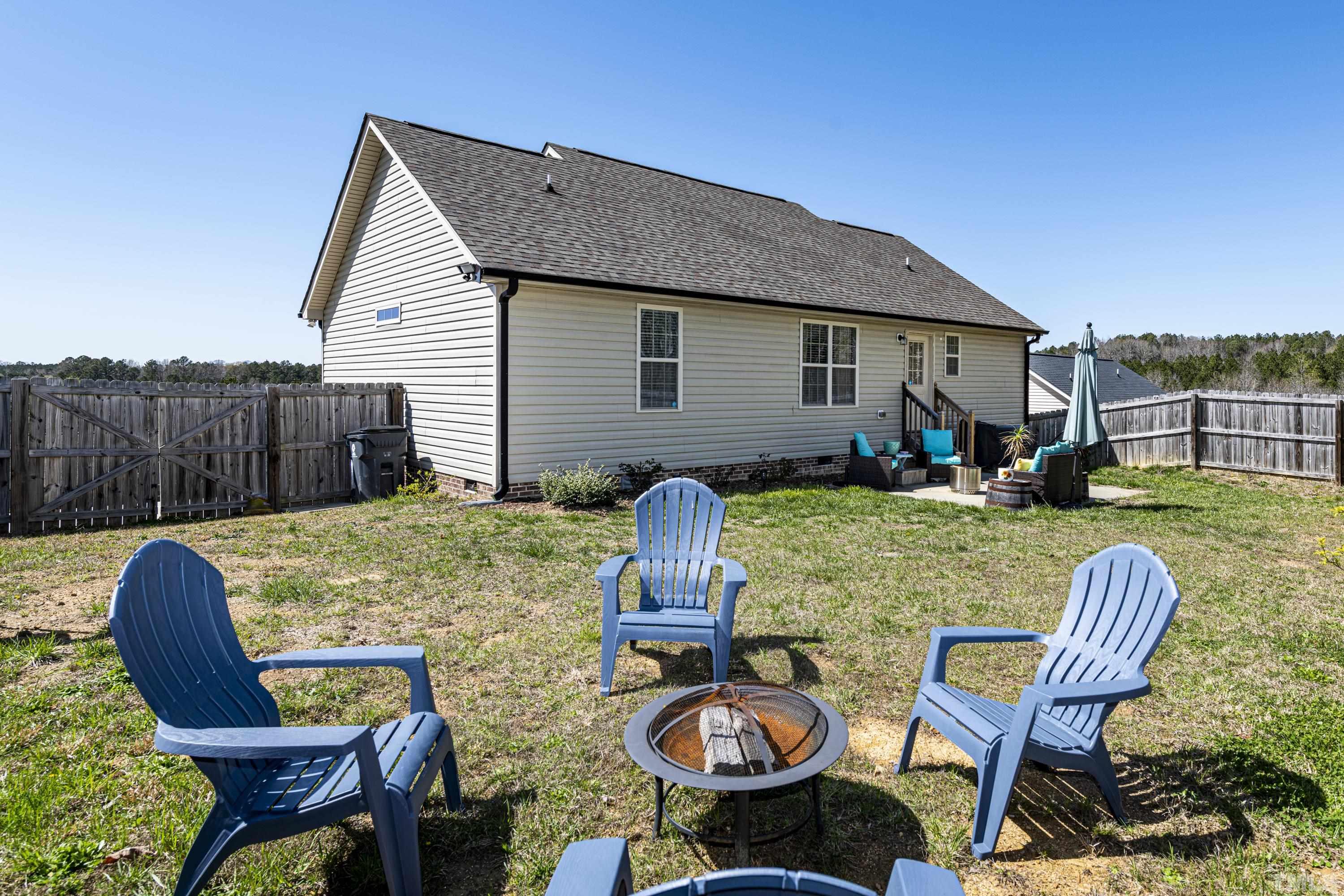 312 Wick Road Stem, NC 27581 - Photo 30 of 34 a view of a house with backyard and sitting area