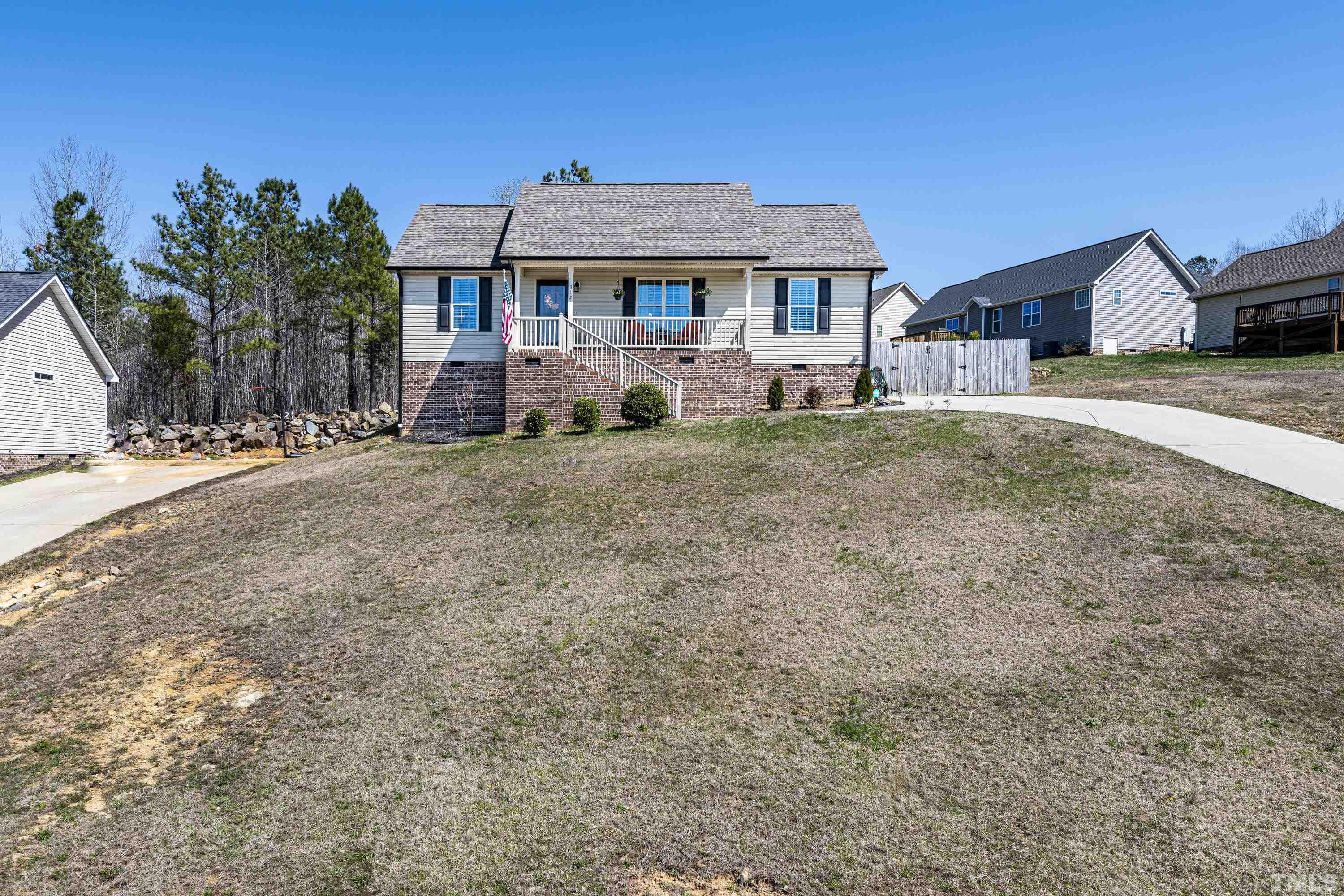 312 Wick Road Stem, NC 27581 - Photo 33 of 34 a front view of a house with a yard