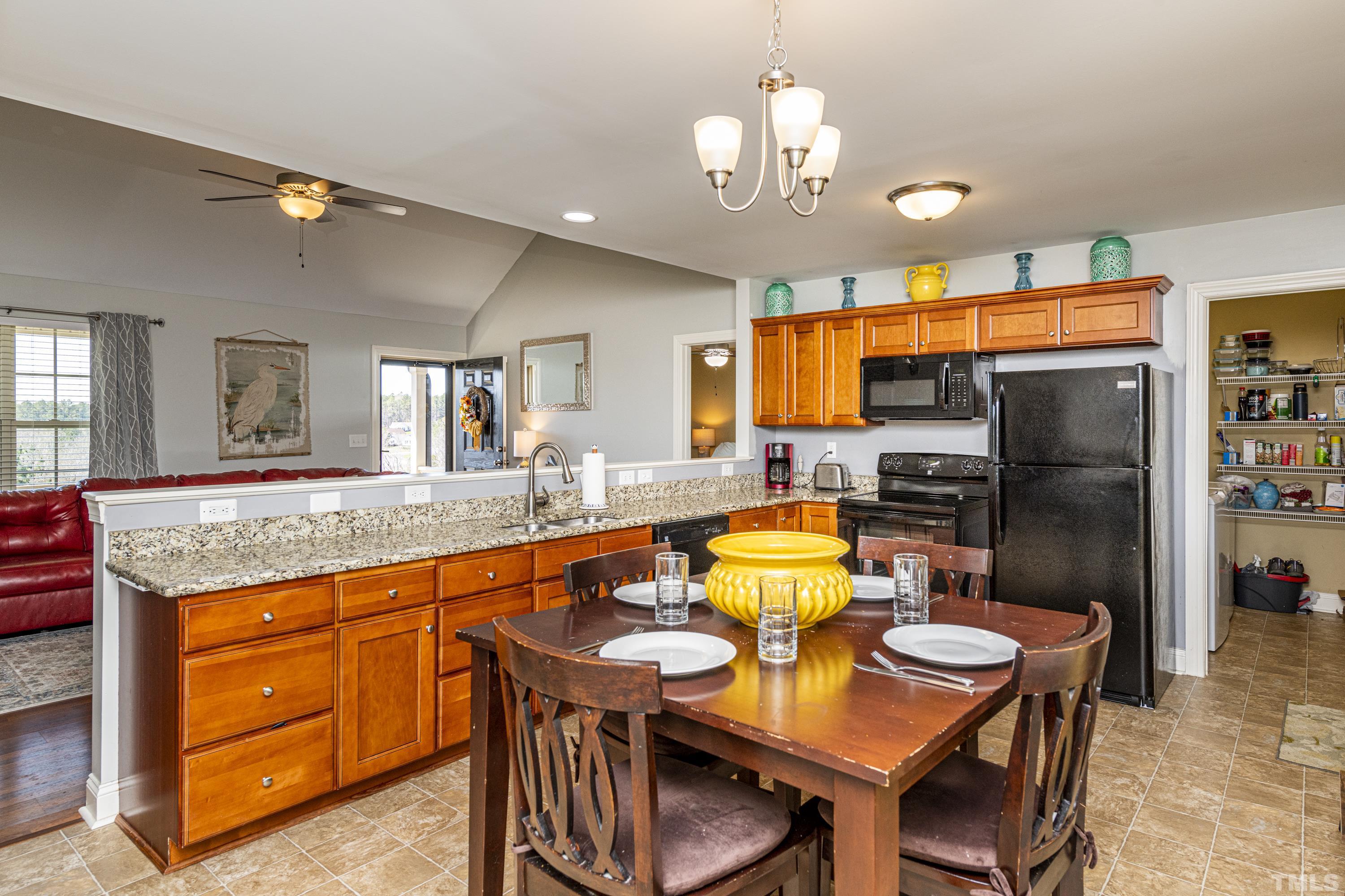 312 Wick Road Stem, NC 27581 - Photo 6 of 34 a kitchen with stainless steel appliances granite countertop a sink and a refrigerator