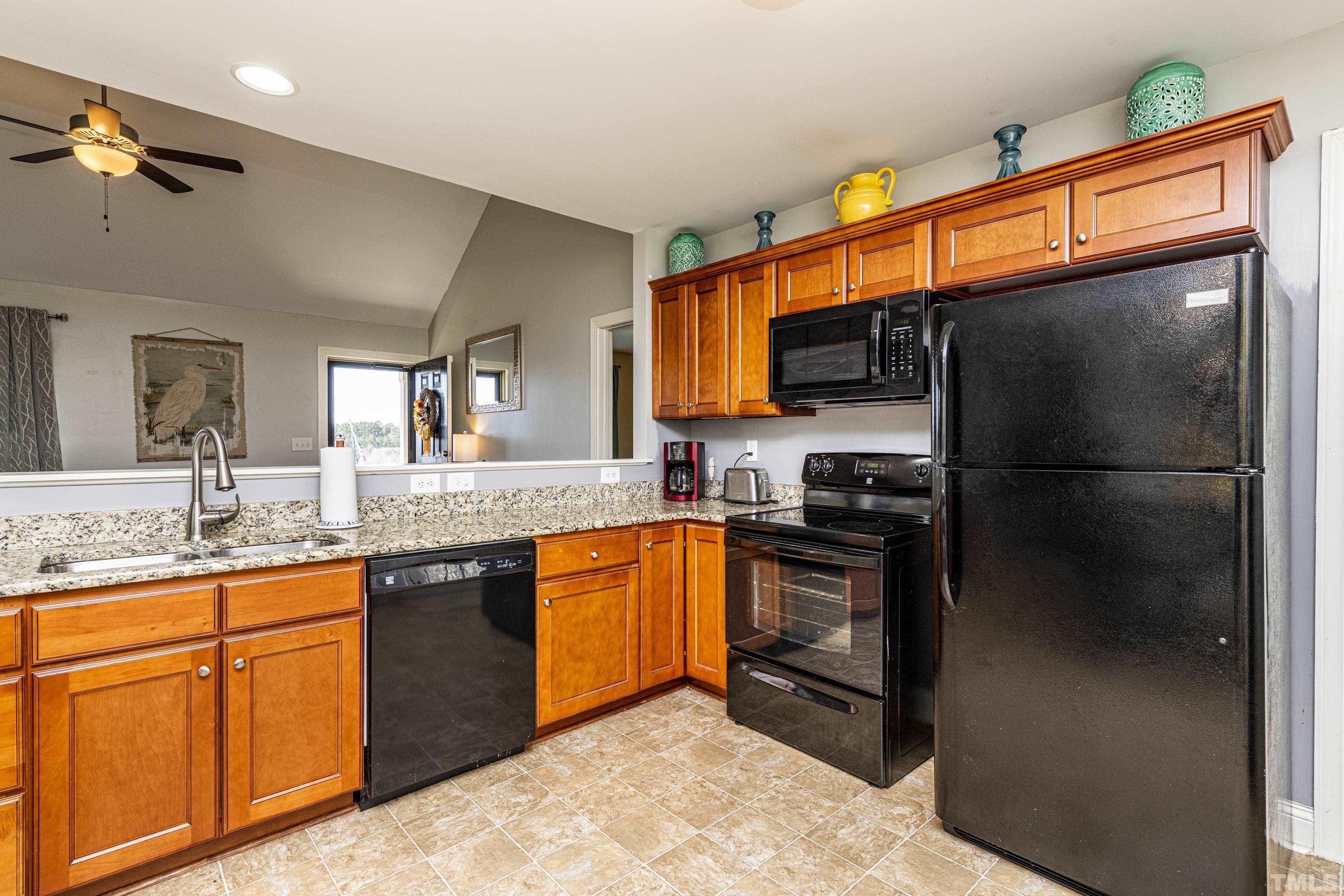 312 Wick Road Stem, NC 27581 - Photo 7 of 34 a kitchen with stainless steel appliances granite countertop a refrigerator and a sink