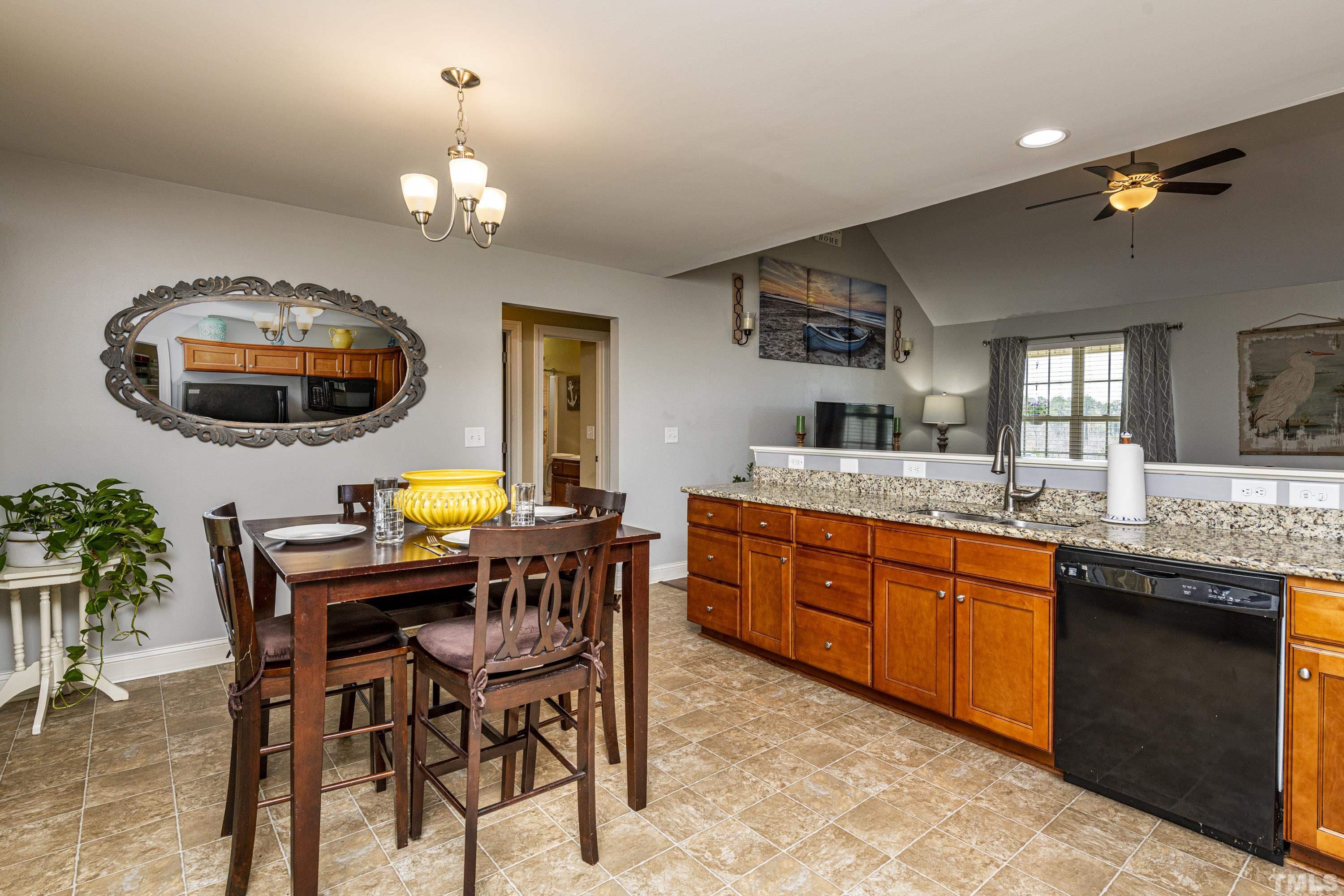 312 Wick Road Stem, NC 27581 - Photo 8 of 34 a view of a dining room with furniture and chandelier
