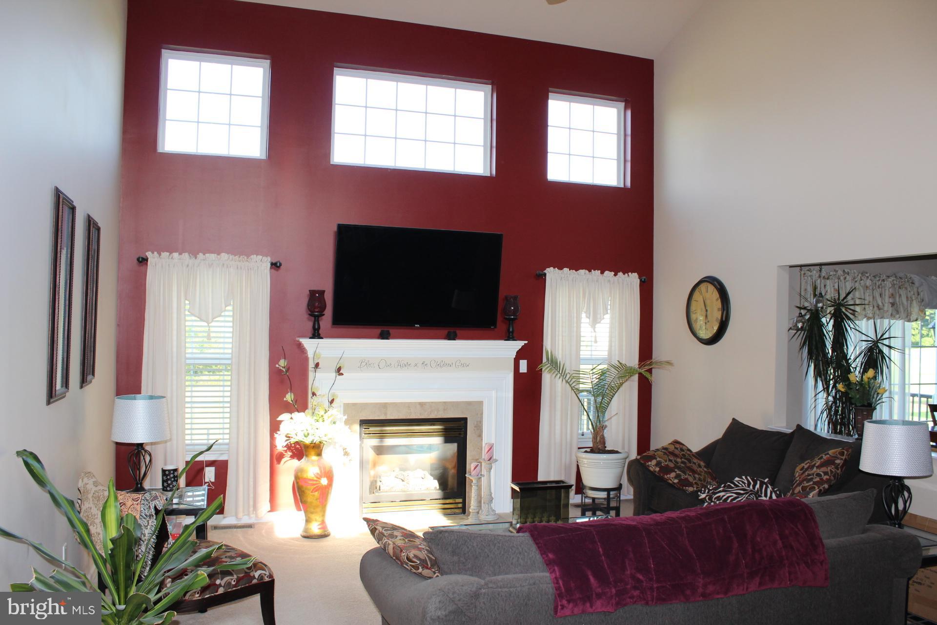 2 Jennifer Court Reading, PA 19608 - Photo 13 of 45 a living room with furniture a fireplace and a flat screen tv