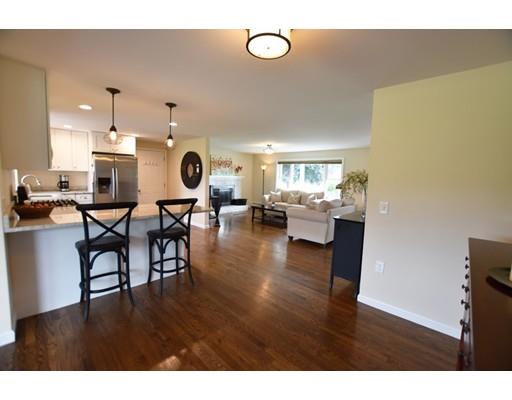 306 Bolton Road Lancaster, MA 01523 - Photo 12 of 30 a living room with lots of wooden furniture and view of kitchen