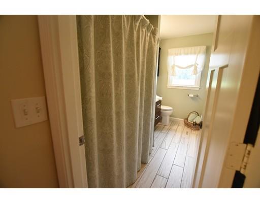 306 Bolton Road Lancaster, MA 01523 - Photo 17 of 30 a bathroom with a sink and a glass door