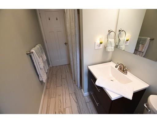 306 Bolton Road Lancaster, MA 01523 - Photo 18 of 30 a bathroom with a sink a mirror and a toilet