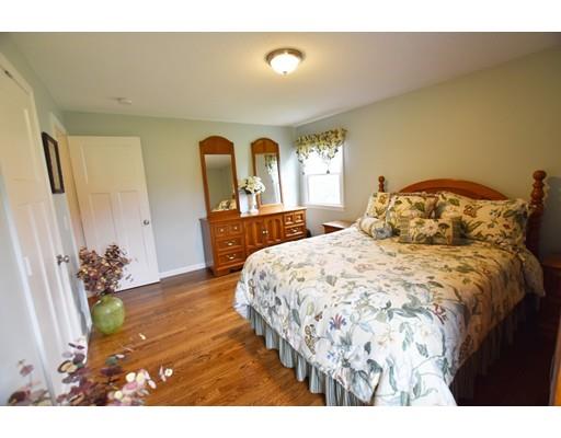 306 Bolton Road Lancaster, MA 01523 - Photo 20 of 30 a bedroom with a bed and a dresser with mirror