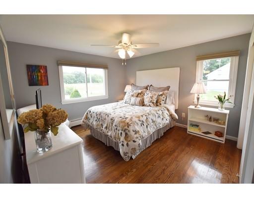 306 Bolton Road Lancaster, MA 01523 - Photo 23 of 30 a bedroom with a bed and a chandelier